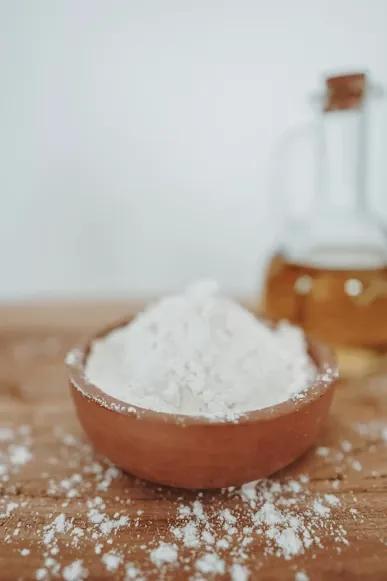 Stone-ground flour in a wooden bowl on a rustic table